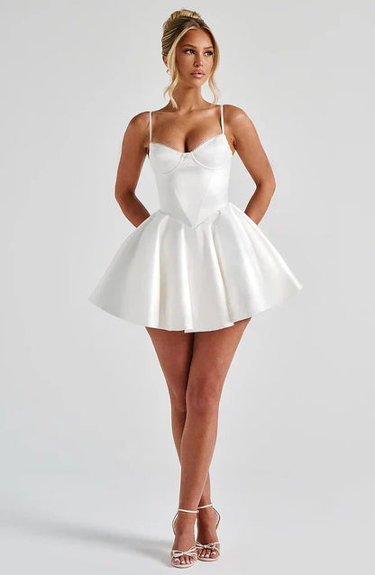 Woman in an ivory Poppy Mini Dress with underwired cups and a voluminous circle skirt, showcasing a timeless style.