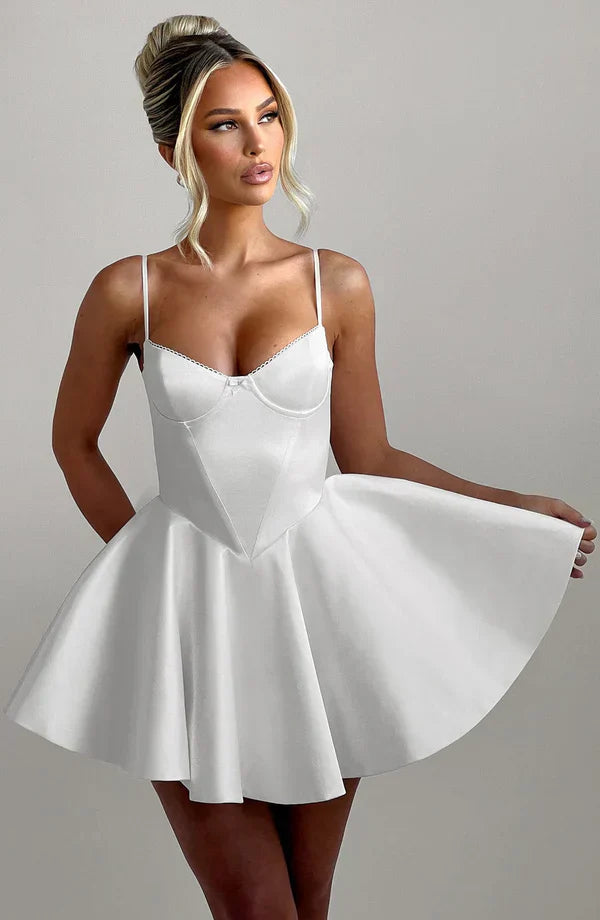 Model wearing Poppy Mini Dress in ivory, showcasing its underwired cups and full circle skirt.